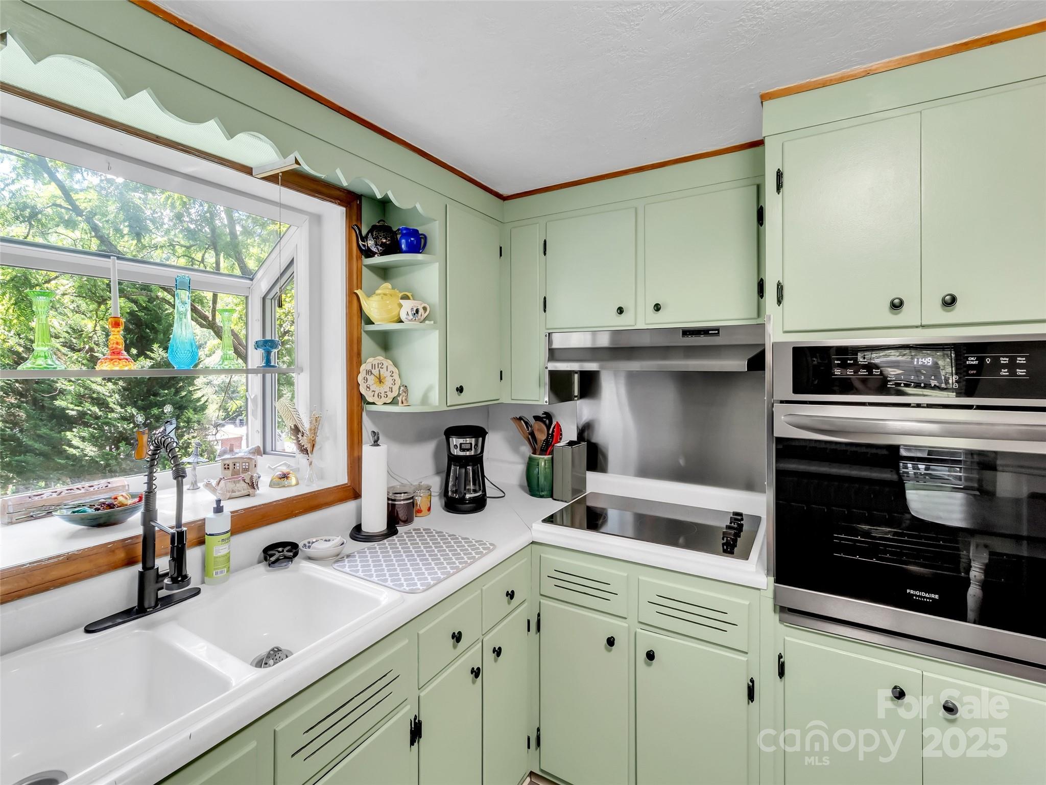 340 Mauney Cove Road Waynesville, NC 28786 - Photo 12 of 35 a kitchen with stainless steel appliances sink stove and cabinets