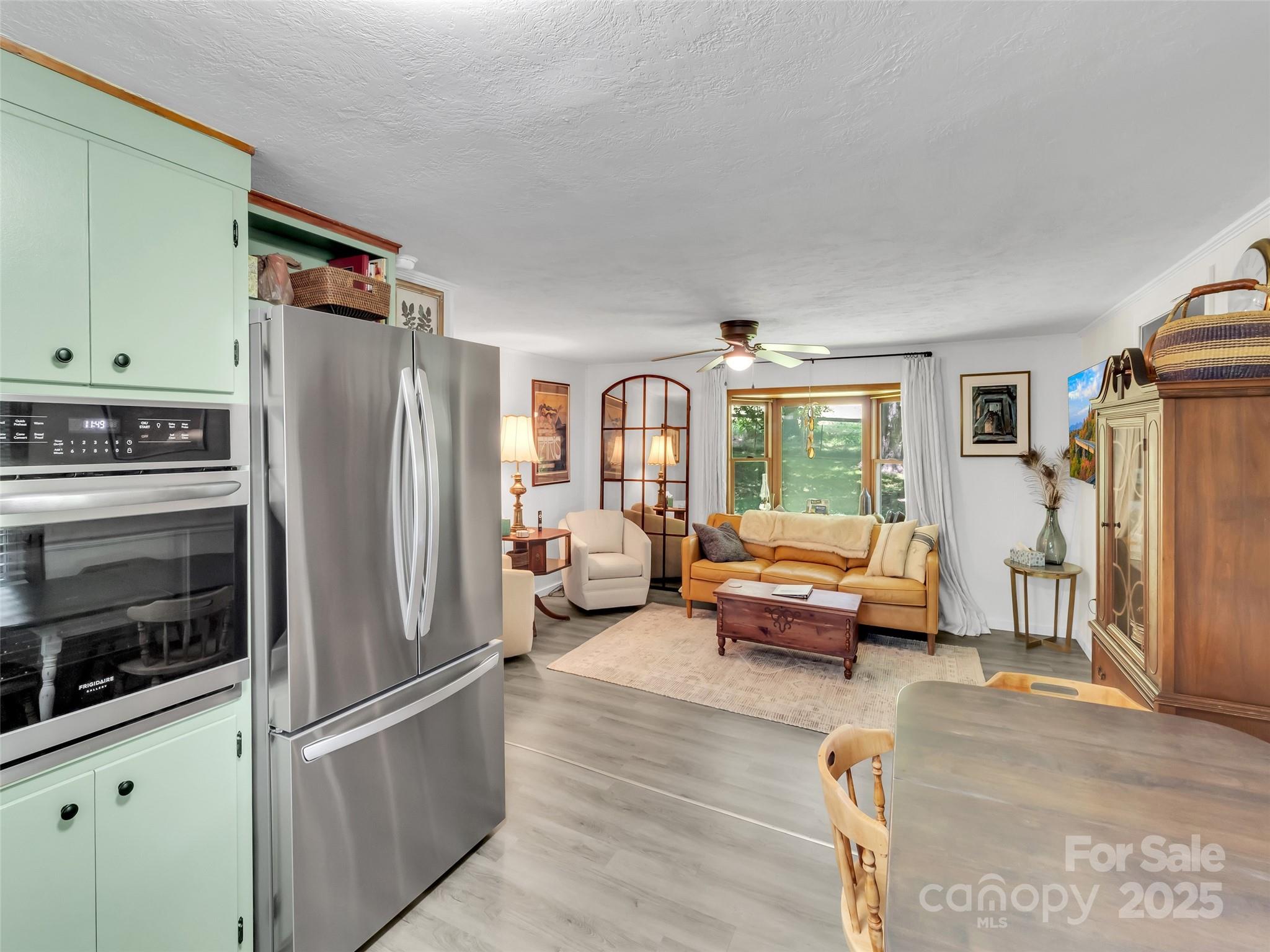 340 Mauney Cove Road Waynesville, NC 28786 - Photo 13 of 35 a living room with furniture windows and a refrigerator