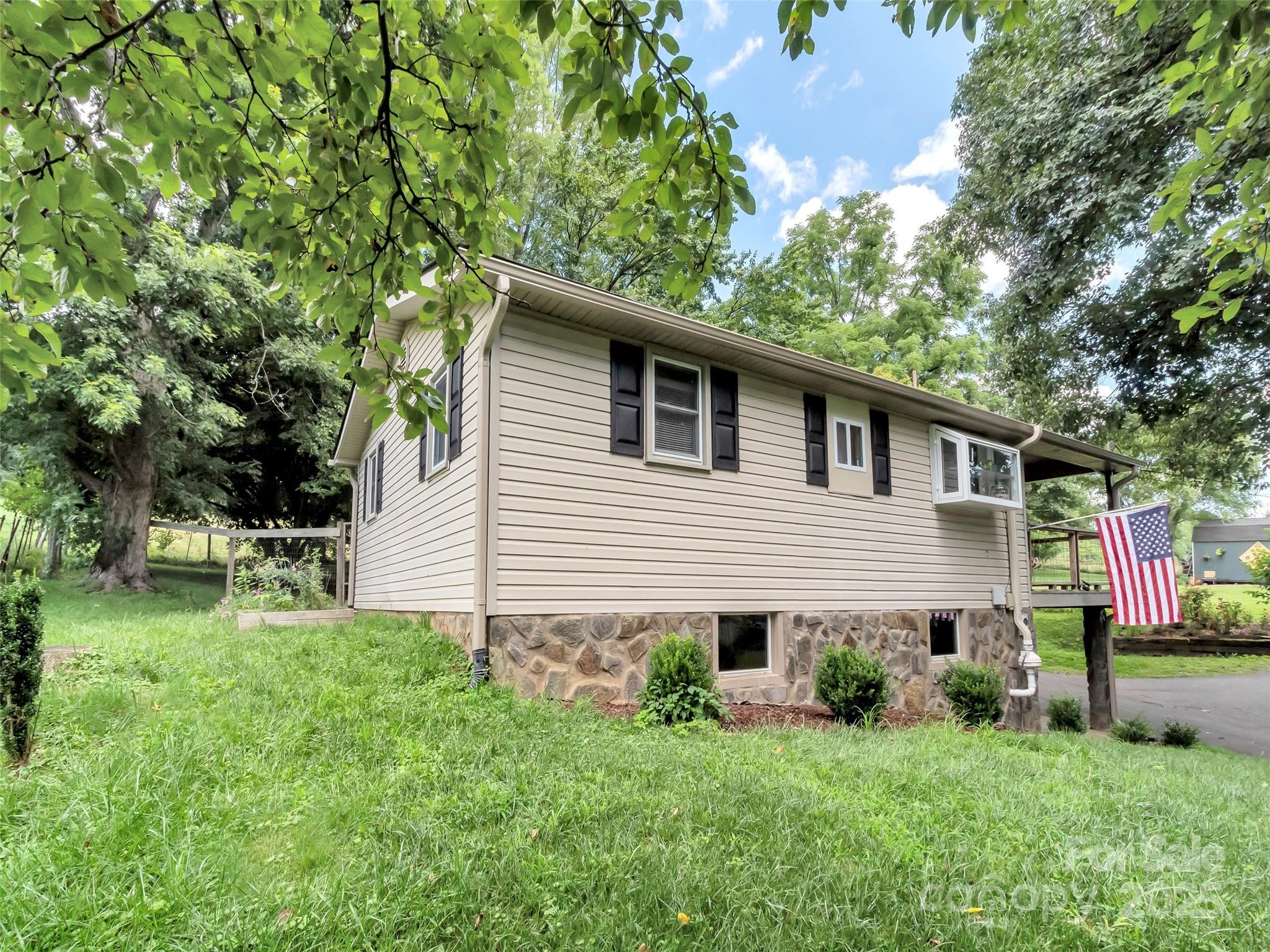 340 Mauney Cove Road Waynesville, NC 28786 - Photo 25 of 35 a front view of house with yard and trees