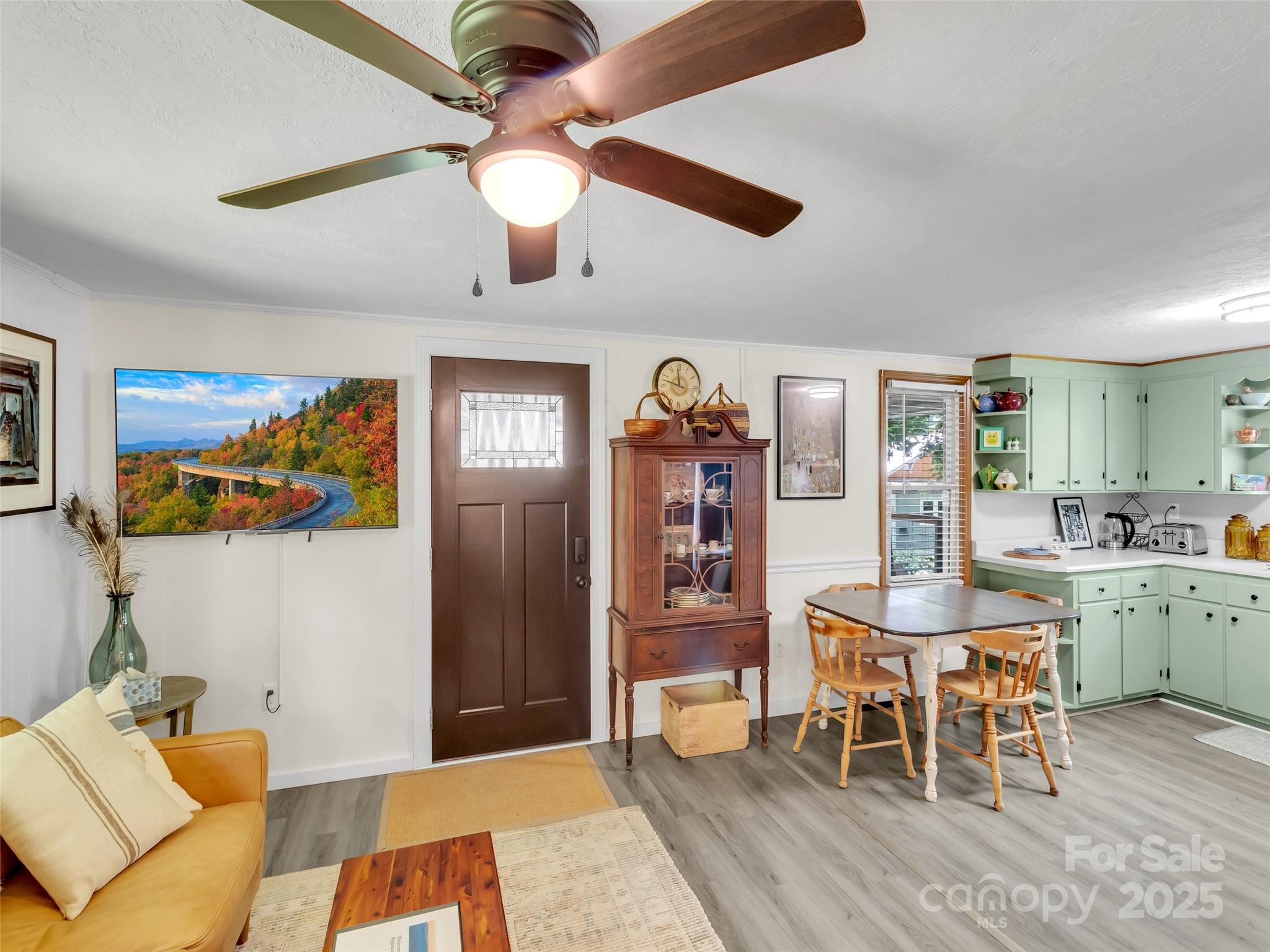 340 Mauney Cove Road Waynesville, NC 28786 - Photo 8 of 35 a view of a dining room with furniture and wooden floor