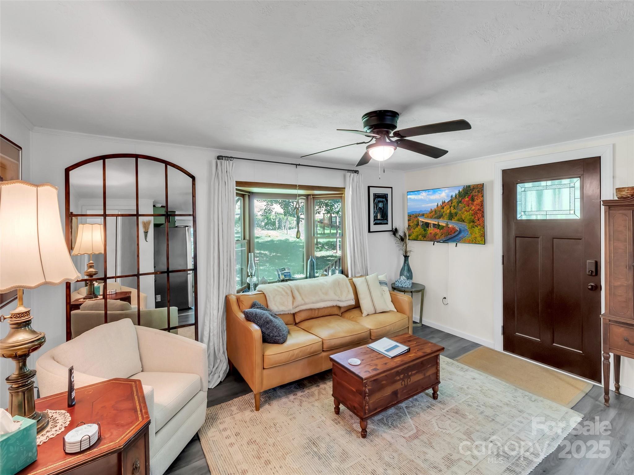 340 Mauney Cove Road Waynesville, NC 28786 - Photo 9 of 35 a living room with furniture and a large window