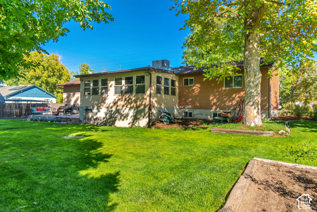 432 South 600 East Payson, UT 84651 - Photo 33 of 34 Expansive green lawn with mature trees, a concrete patio area, and a raised garden bed
