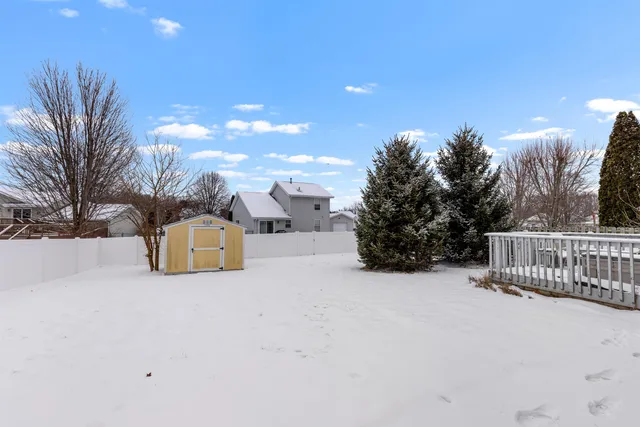 a view of a house with a snow in the background