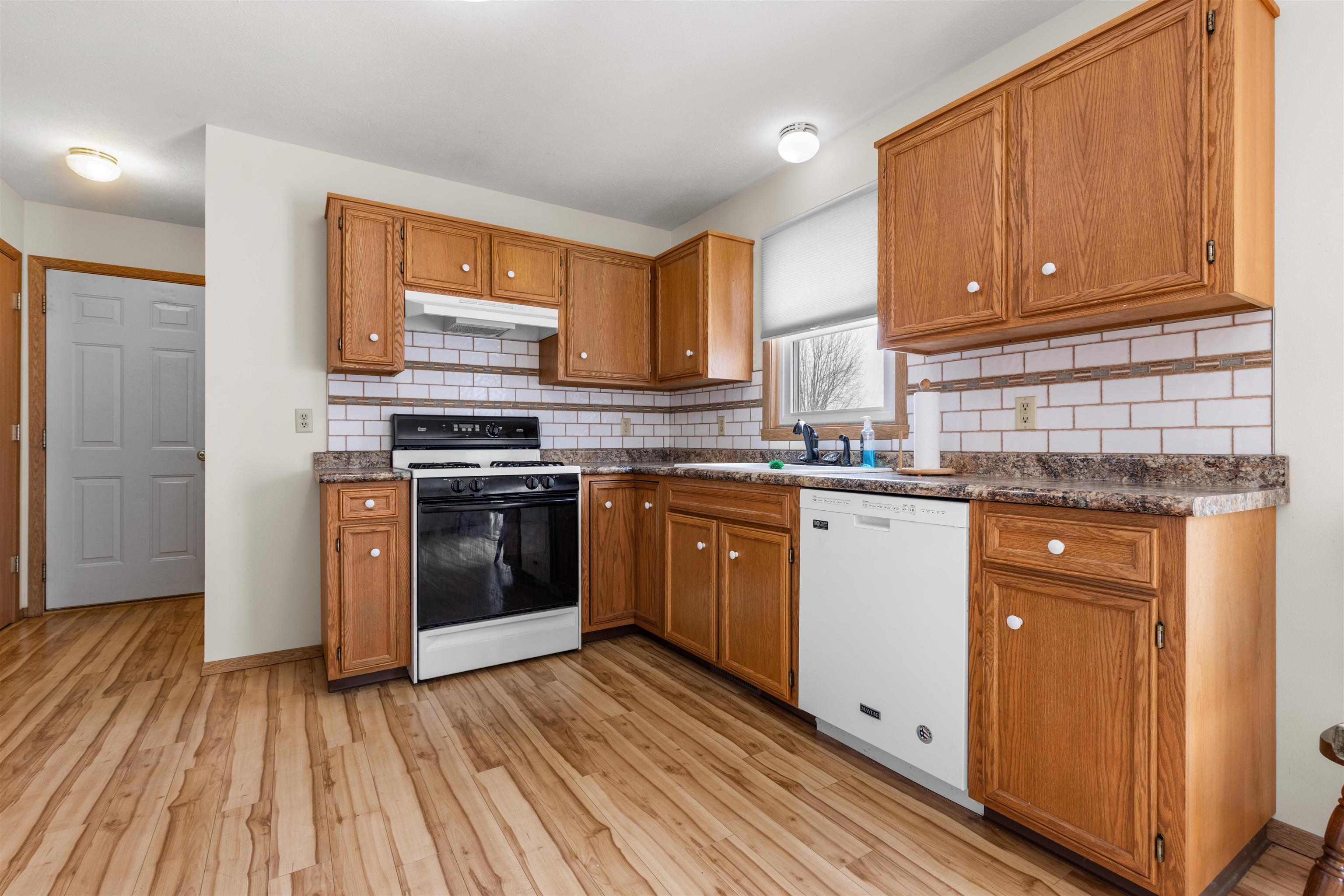4193 Old Gate Road Rockford, IL 61109 - Photo 3 of 18 a kitchen with a white stove top oven and sink