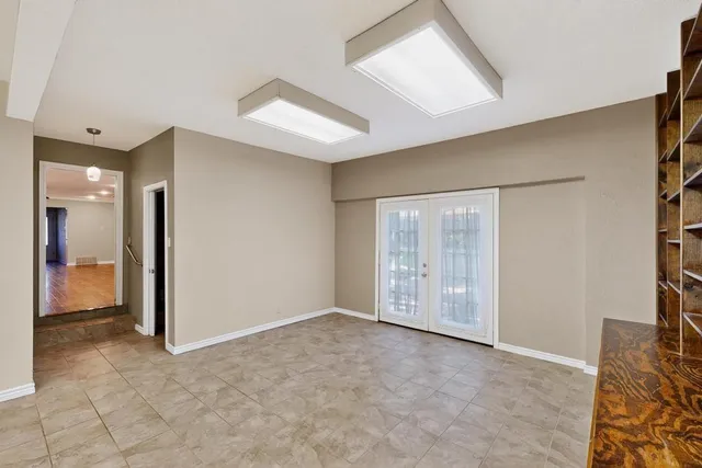a view of a dining room and livingroom with furniture window and wooden floor