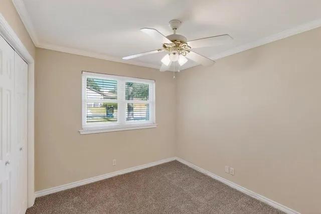 a bedroom with a bed and a potted plant