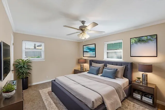 an empty room with fan and windows