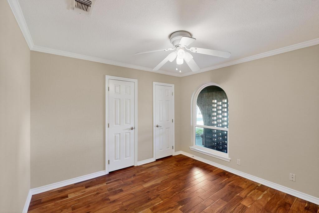 1505 Cedar Ridge Terrace Euless, TX 76039 - Photo 22 of 38 an empty room with wooden floor fan and windows