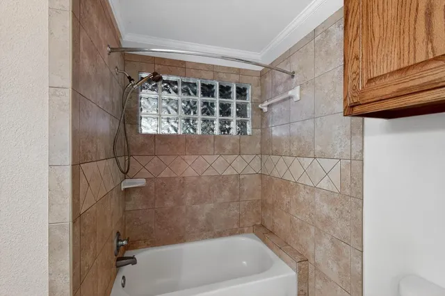 a bathroom with a granite countertop sink a mirror and shower