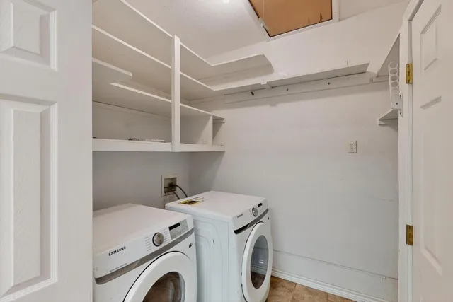 a backyard of a house with barbeque oven table and chairs