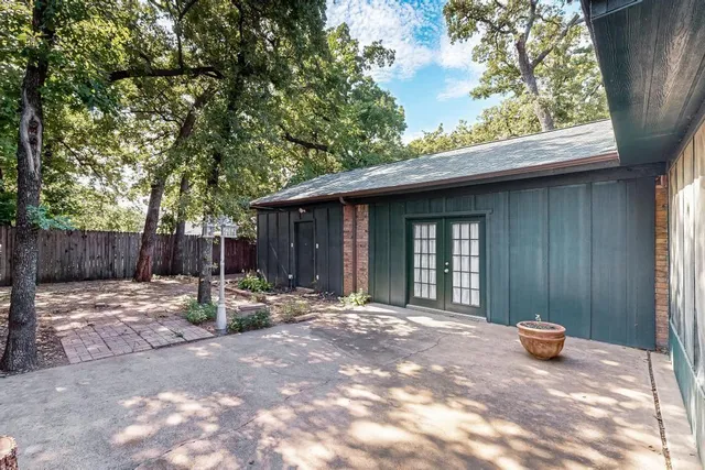 a backyard of a house with table and chairs
