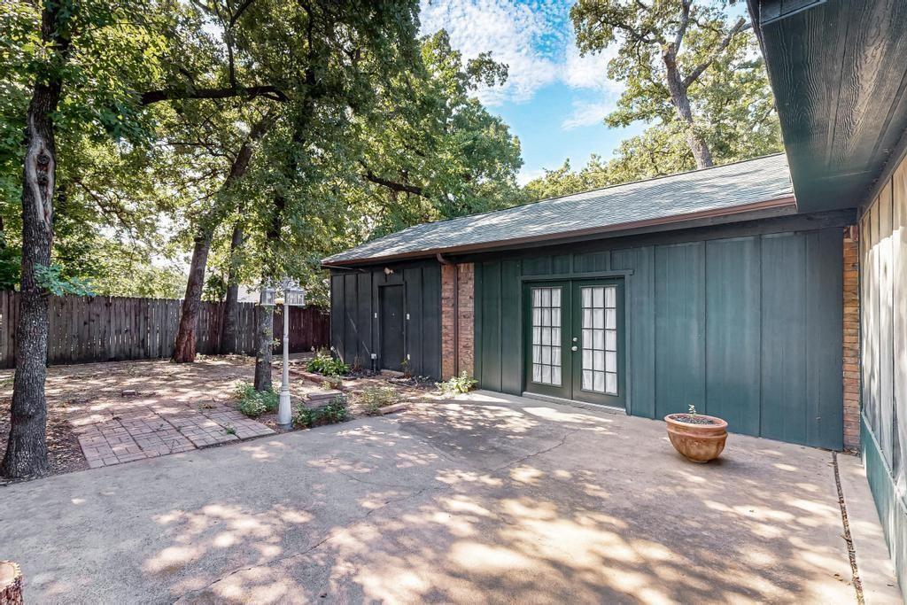 1505 Cedar Ridge Terrace Euless, TX 76039 - Photo 28 of 38 a backyard of a house with barbeque oven table and chairs