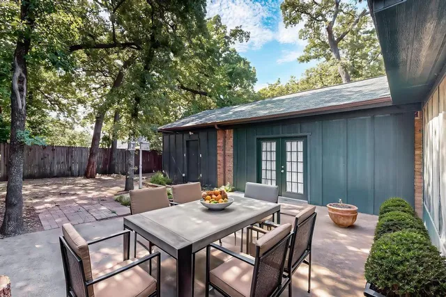 a table and chairs under an umbrella