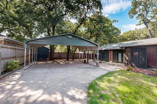 a backyard of a house with barbeque oven