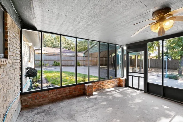a backyard of a house with barbeque oven and outdoor seating