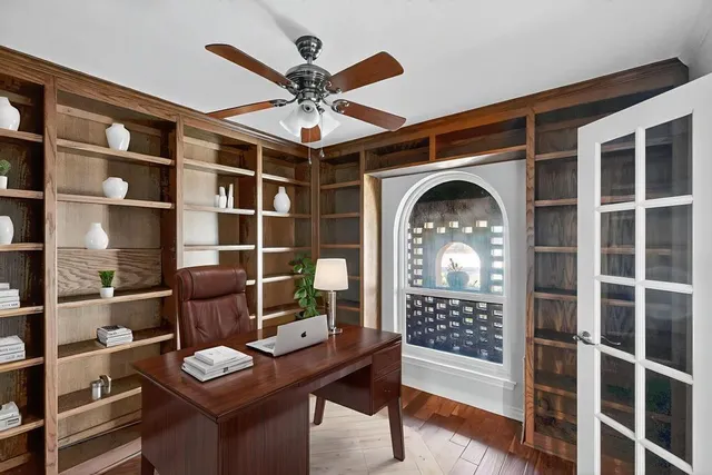 a view of a workspace with furniture and a chandelier