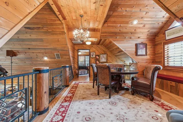 a view of a chairs and table in the back yard of the house