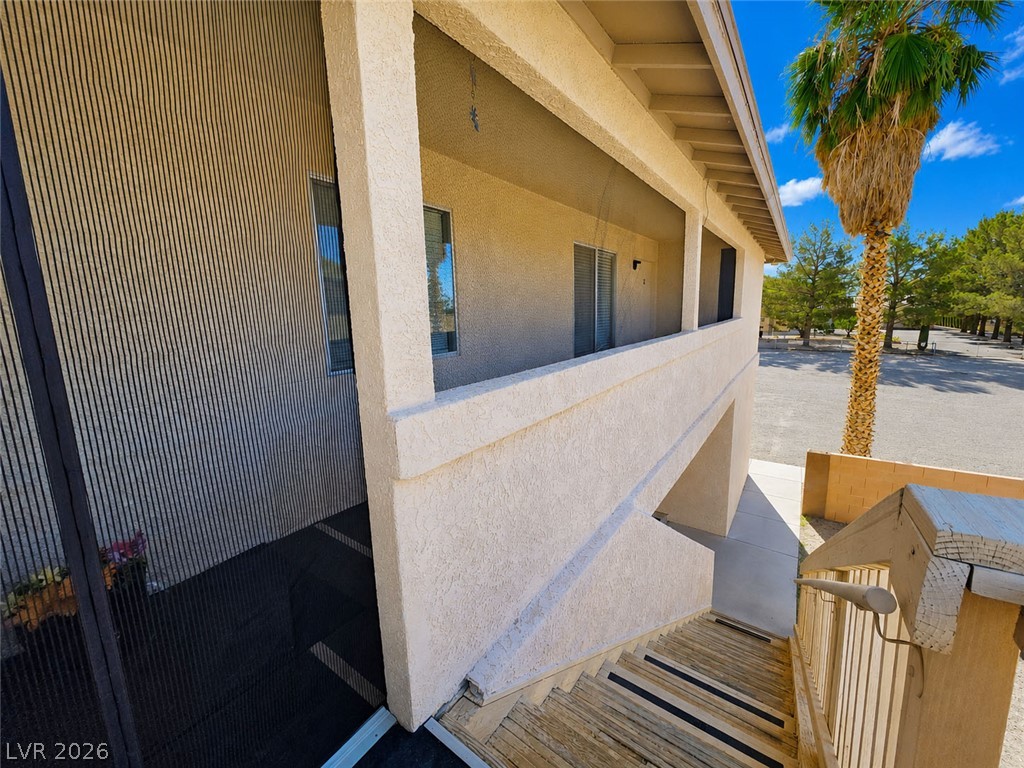 1444 Star Road, Unit 3 Pahrump, NV 89048 - Photo 4 of 35 A desert oasis awaits, with a well-maintained exterior and a private balcony for relaxation.