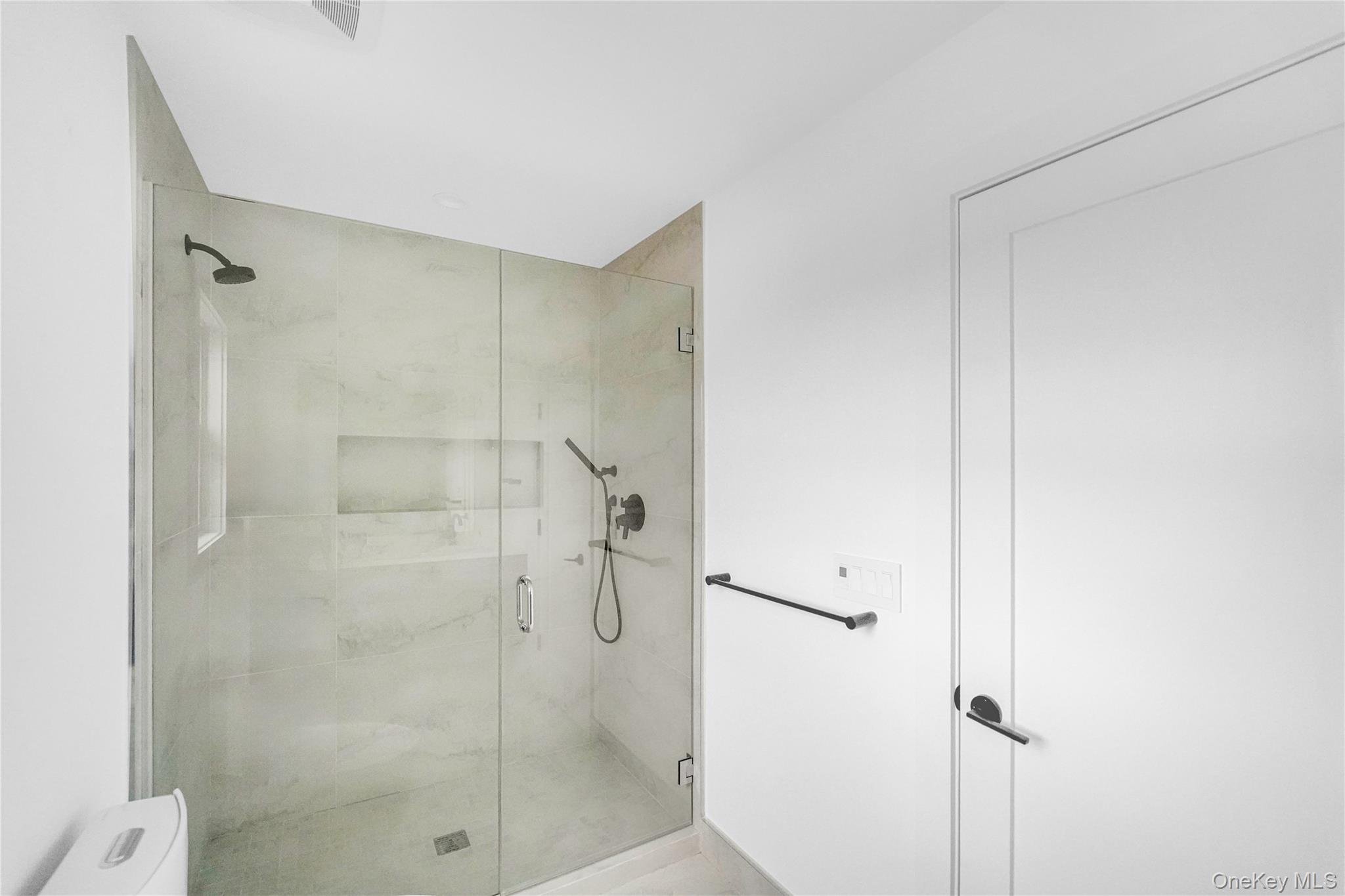 68 Foster Avenue, Unit 4 Hampton Bays, NY 11946 - Photo 12 of 17 a bathroom with a shower