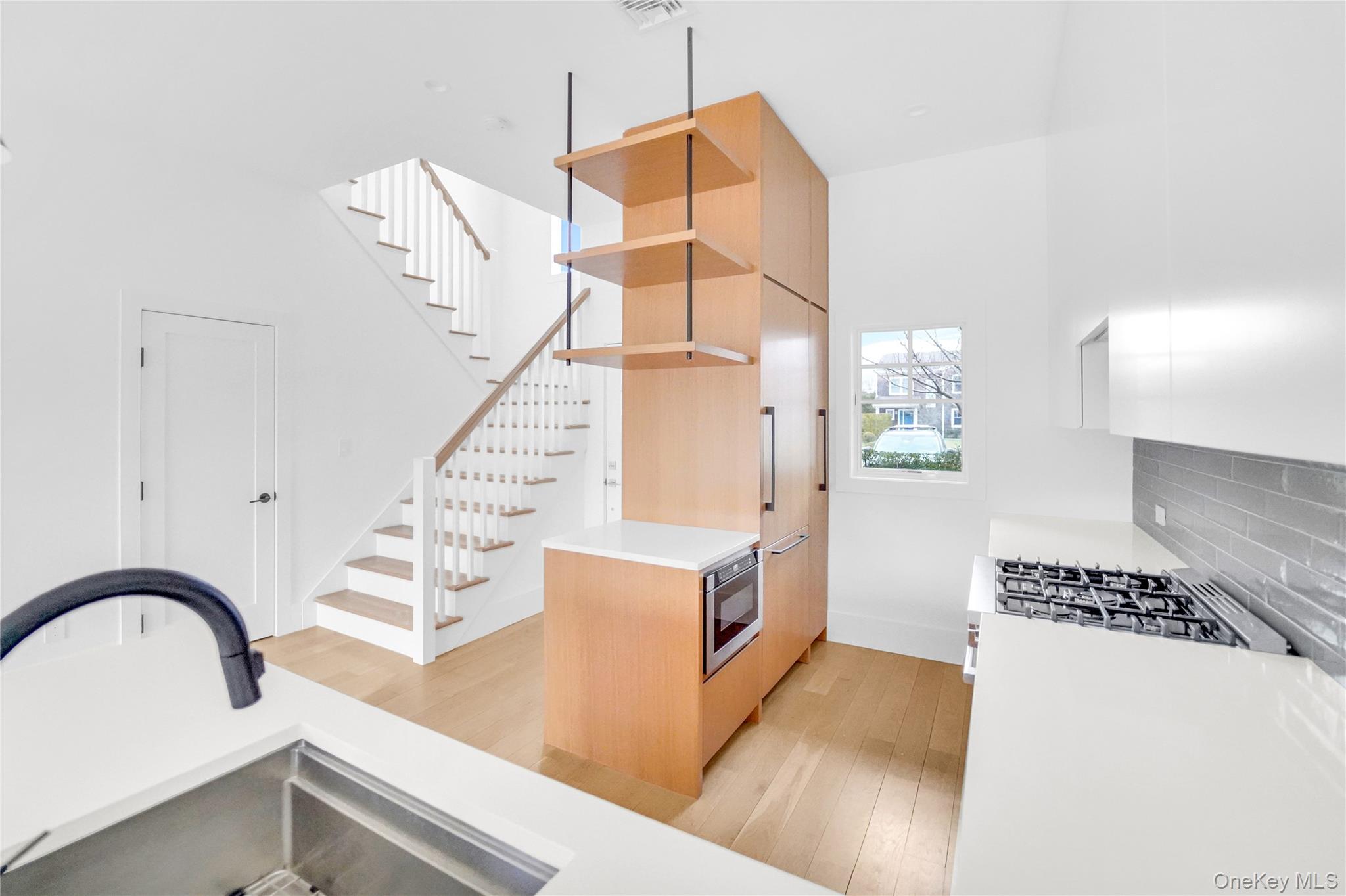 68 Foster Avenue, Unit 4 Hampton Bays, NY 11946 - Photo 6 of 17 a kitchen with a appliances and cabinets