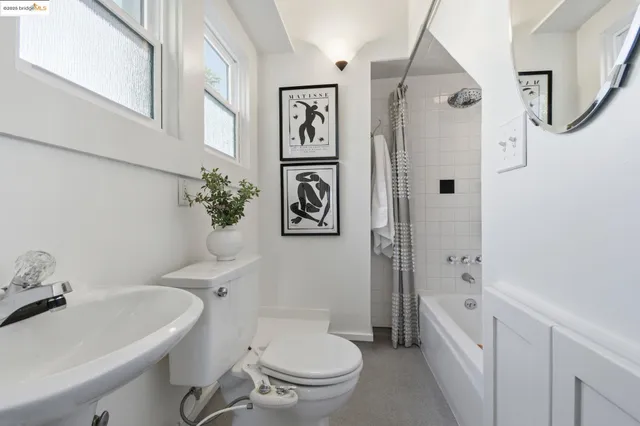 a white toilet sitting next to a bathroom sink