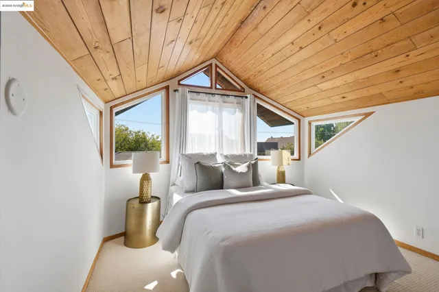 a bedroom with furniture and a large window