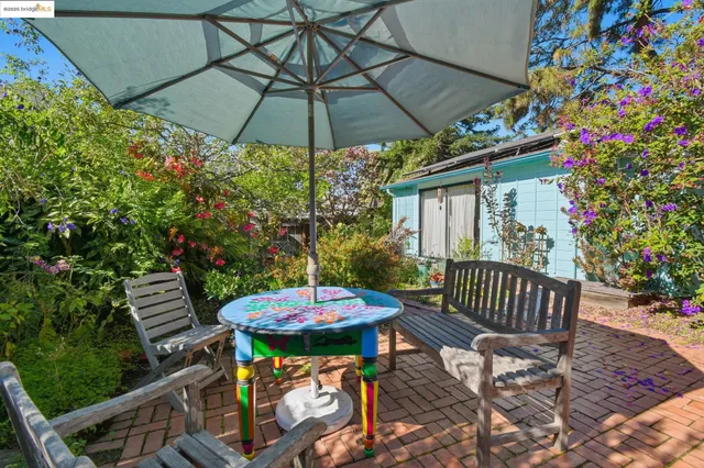 a view of a table and chairs under an umbrella