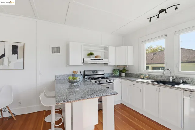 a kitchen with stainless steel appliances granite countertop a sink and cabinets