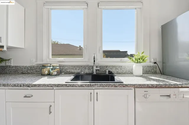 a kitchen with granite countertop a sink and a window