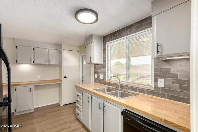a kitchen with a sink stove and cabinets