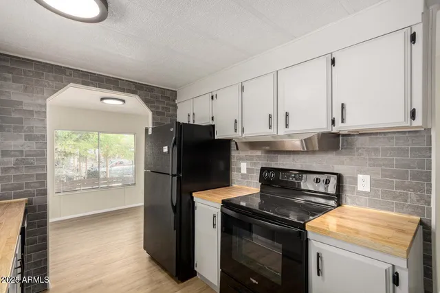 a kitchen with appliances cabinets and a counter top space