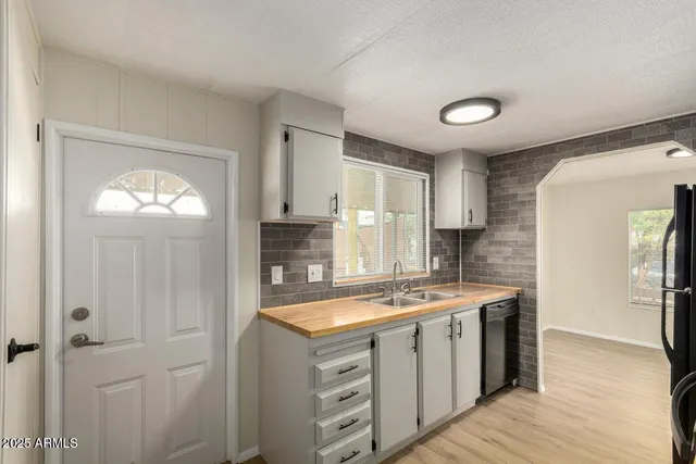 a kitchen with a sink stove and cabinets