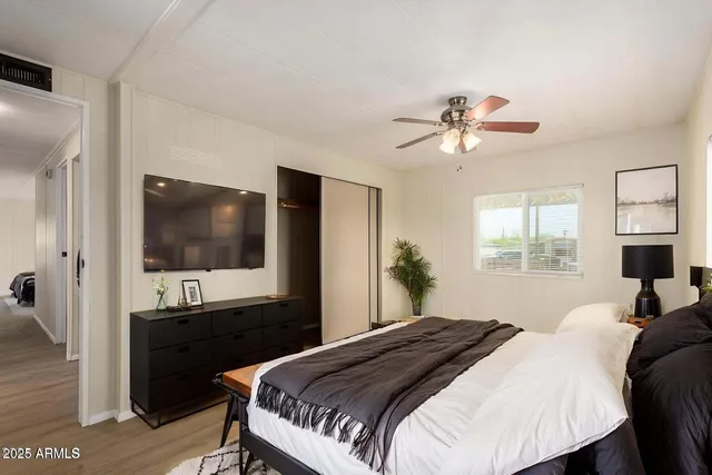 a bedroom with a bed and a flat screen tv