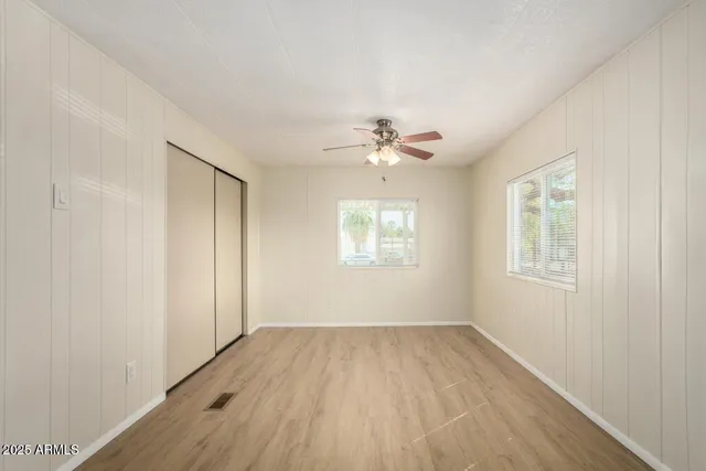 wooden floor in an empty room with a window