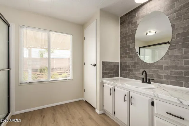 a bathroom with a double vanity sink and a mirror