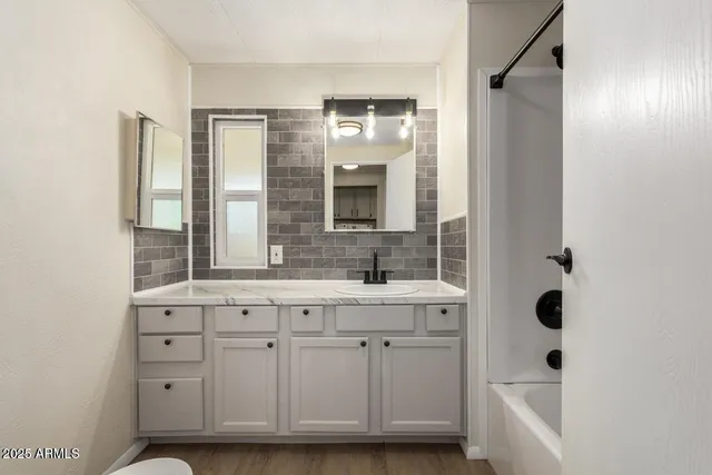 a bathroom with a sink and a mirror