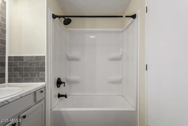 a bathroom with a shower and a bathtub