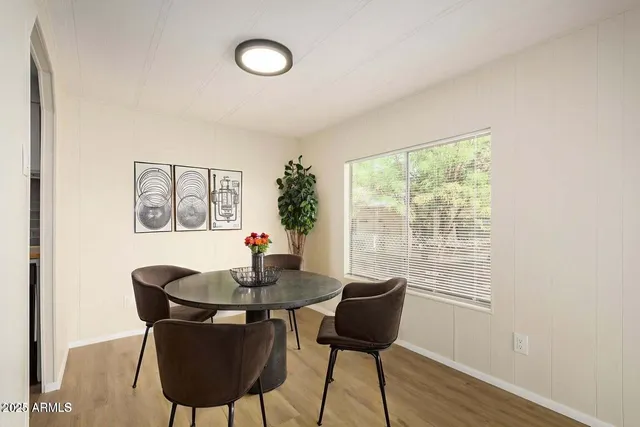 a dining room with furniture and wooden floor