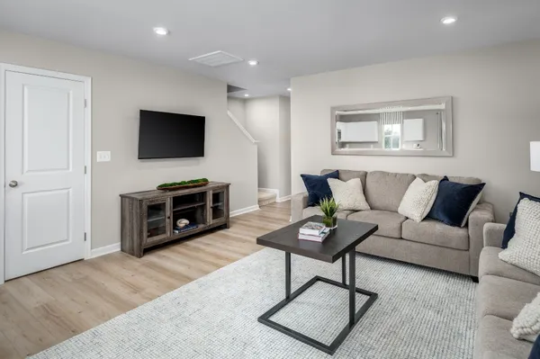 a living room with furniture a fireplace and a flat screen tv