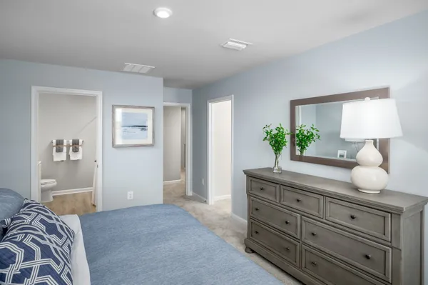 a bedroom with a bed and a dresser in it