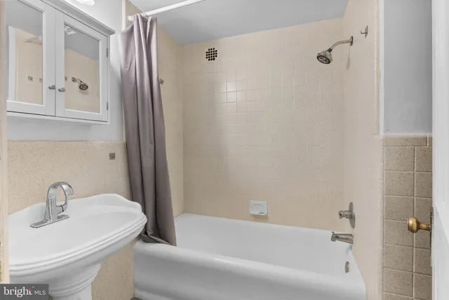a white bath tub sitting next to a white sink