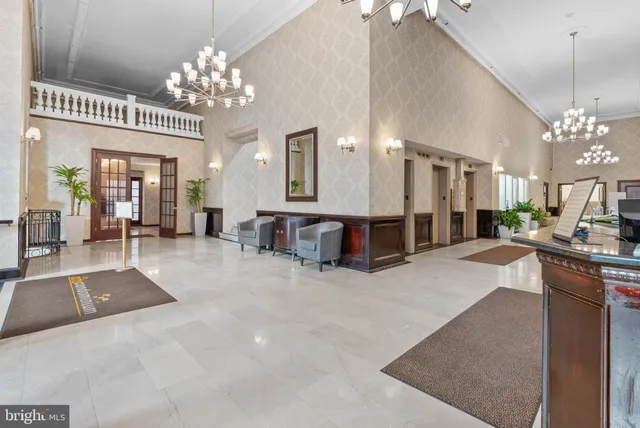 a large hall with kitchen island granite countertop furniture and chandelier