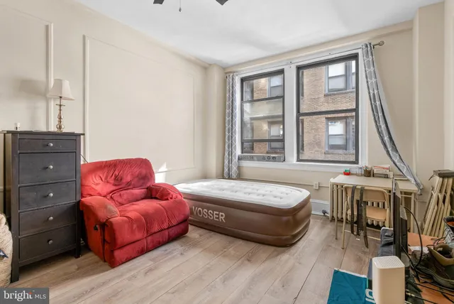 a bedroom with a bed and a dresser