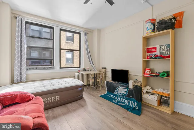 a bedroom with furniture and a flat screen tv