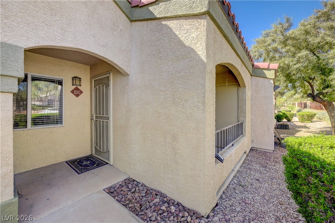7885 West Flamingo Road, Unit 1050 Las Vegas, NV 89147 - Photo 4 of 62 A welcoming arched entryway leads to this home's inviting front door, surrounded by easy-care landscaping.