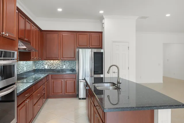 a spacious bathroom with a granite countertop sink and a mirror