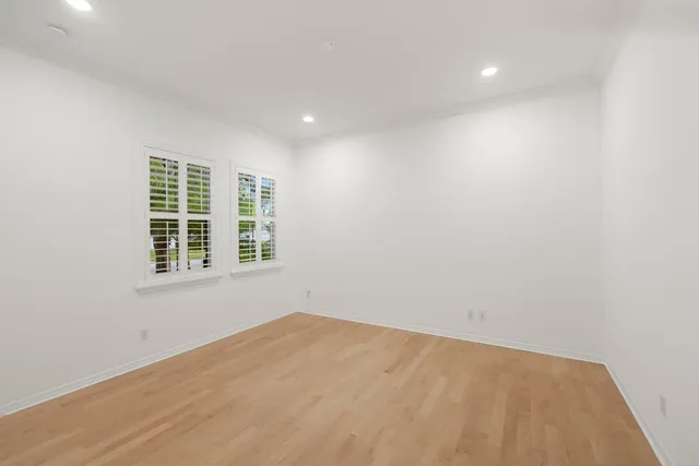 a view of house with a yard and potted plants