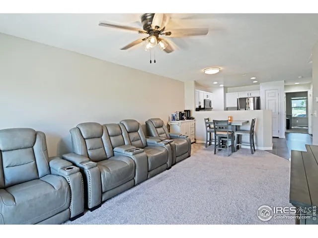 a living room with furniture and kitchen view