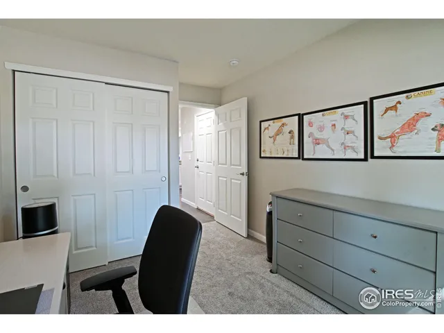 a living room with furniture and a painting on the wall