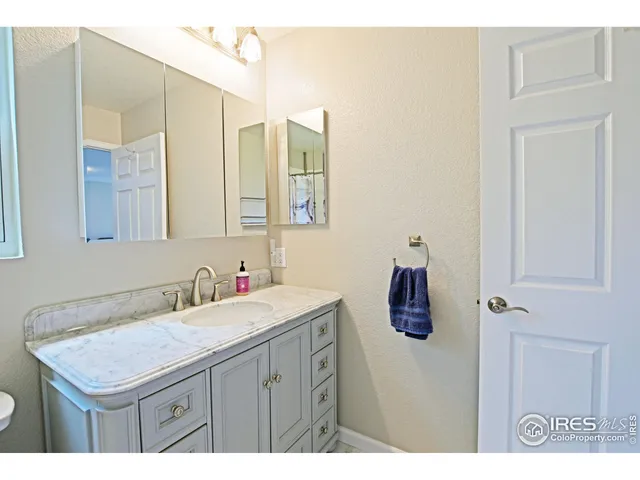 a bathroom with a sink vanity and a mirror